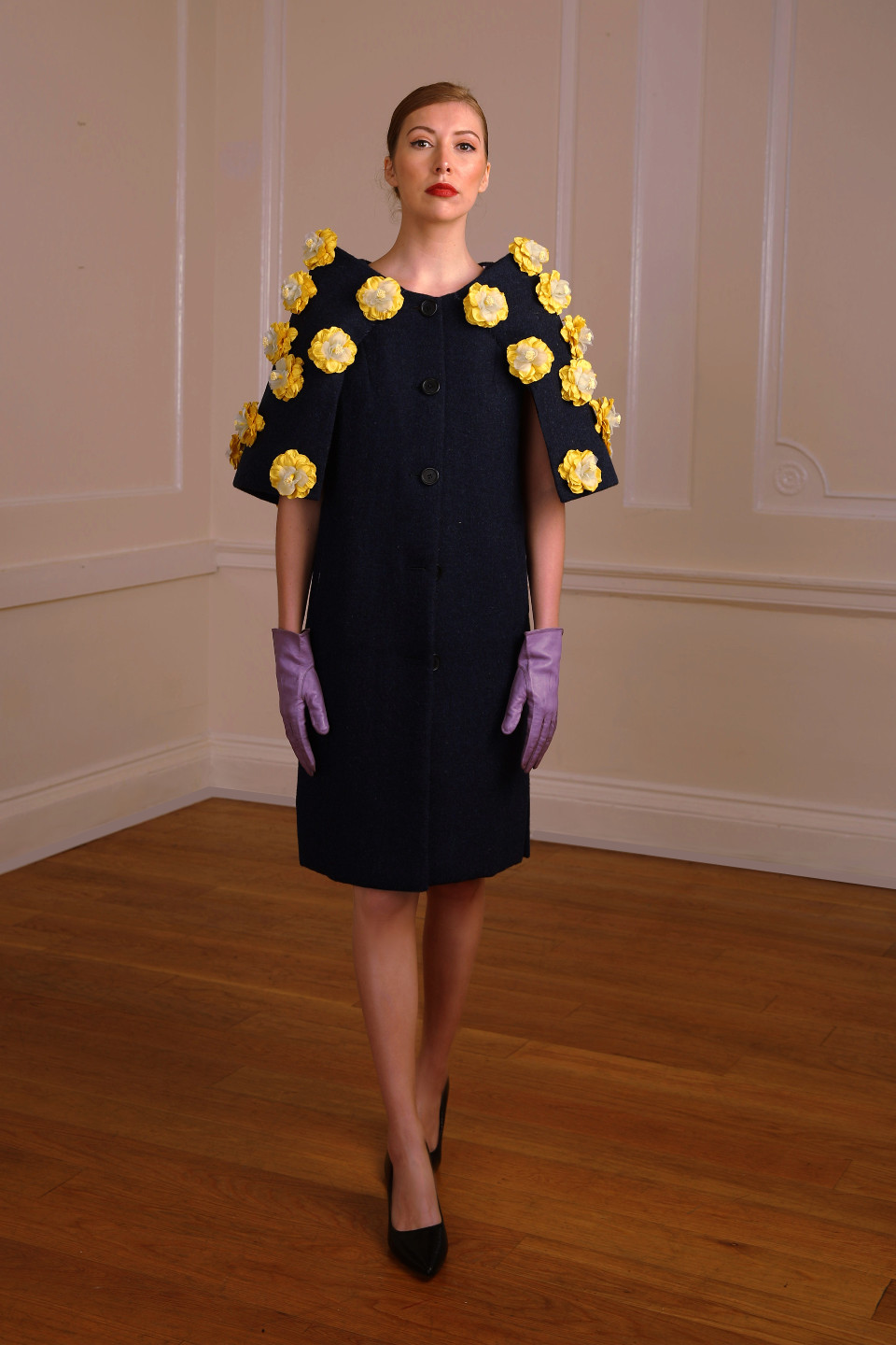 High end coat 100% wool tweed in a navy colour and adorned by silk flowers in yellow