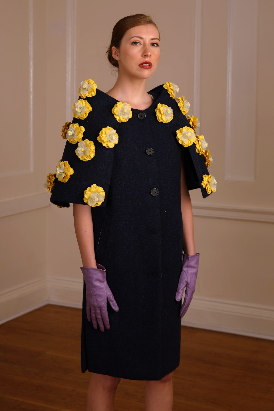 High end coat 100% wool tweed in a navy colour and adorned by silk flowers in yellow
