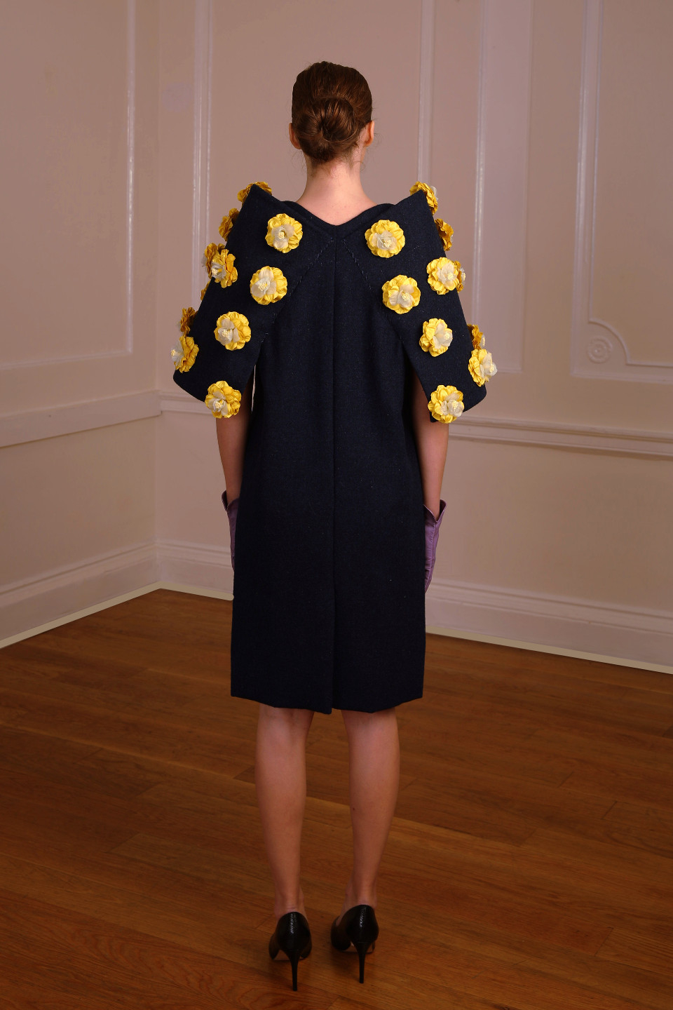 High end coat 100% wool tweed in a navy colour and adorned by silk flowers in yellow